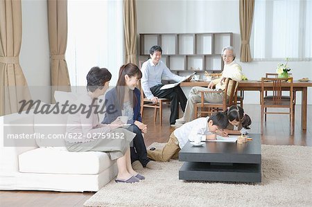 Children painting with family in living room