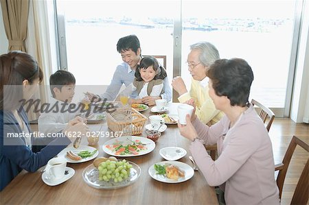 Asian family having breakfast together