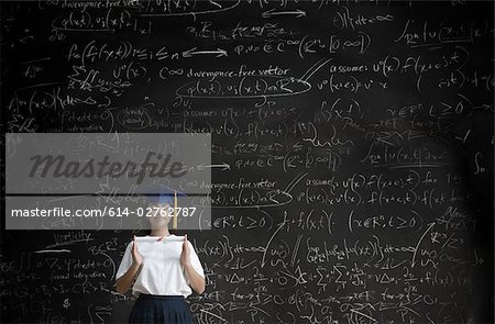 Graduating girl in front of blackboard