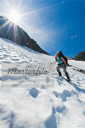 A female climber walking down a mountain