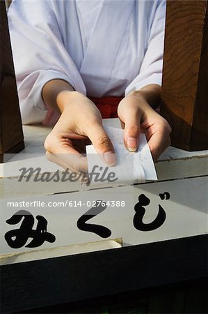A woman holding a omikuji