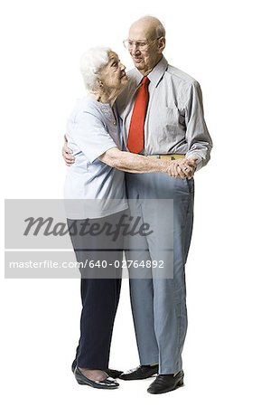 Elderly couple dancing together