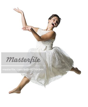 Woman in white dress jumping
