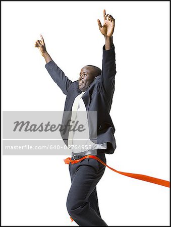 A running businessman takes first place as he crosses the finish line