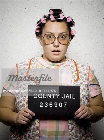 Mug shot of woman in curlers