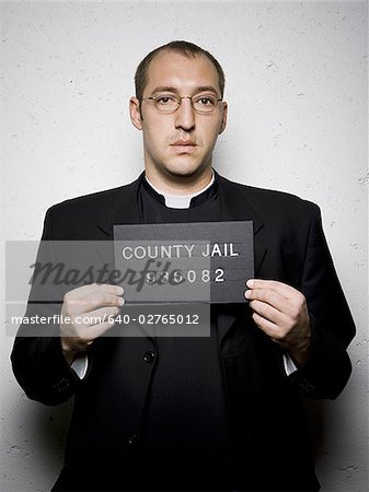Mug shot of priest with glasses