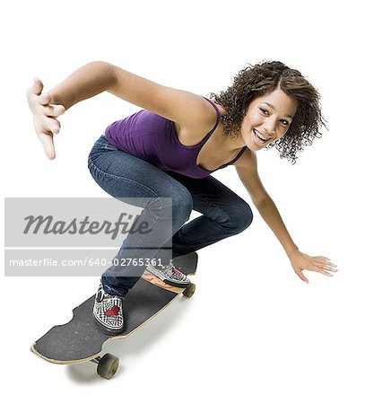 Girl with braces on skateboard smiling
