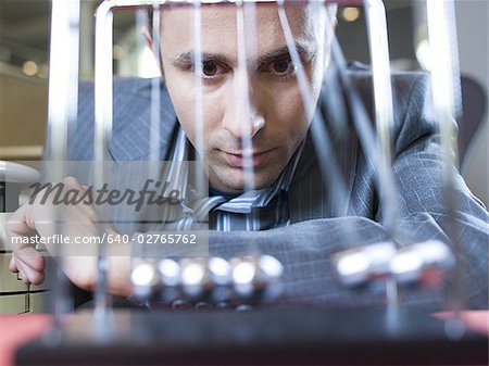 Close-up of businessman watching a Newton's cradle