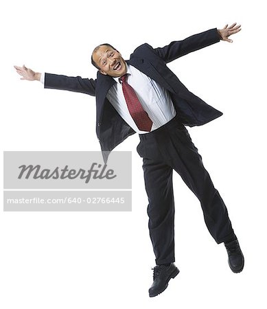 Portrait of a businessman jumping with his arms outstretched