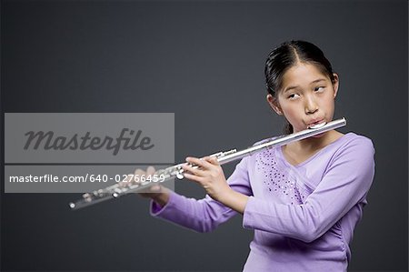 Close-up of a girl playing the flute