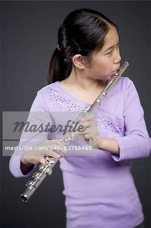 Close-up of a girl playing the flute