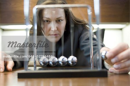 Close-up of a businesswoman looking at a pendulum