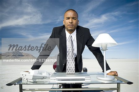 Portrait of a businessman leaning over a table