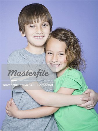 Portrait of a boy embracing his sister