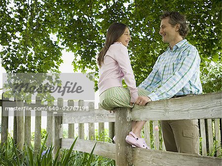 Low angle view of a man and his daughter smiling