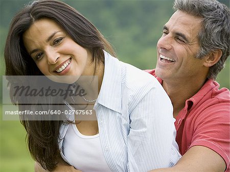 Close-up of a man and a woman smiling