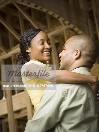 Profile of a young man embracing a young woman and smiling