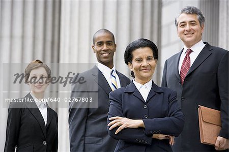 Portrait of  lawyers smiling in front of a courthouse