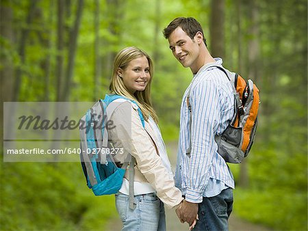 Portrait of a young couple holding hands and smiling