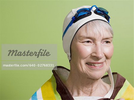 Close-up of a senior woman wearing a swimming cap and swimming goggles