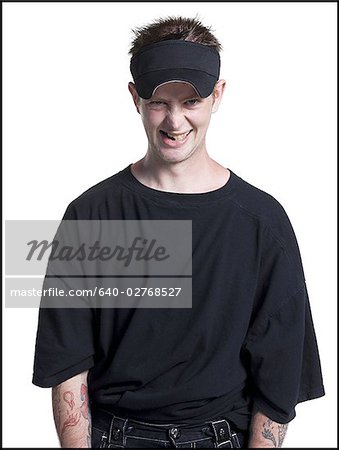 Disheveled man with a visor grinning