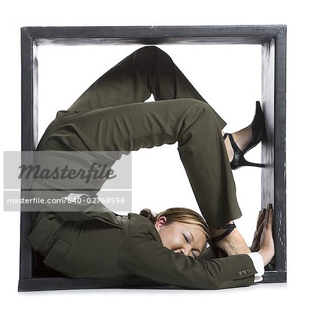 Female contortionist businesswoman inside the box