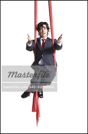 Businessman tangled in red drapes