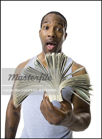 African American holding a pile of dollar bills