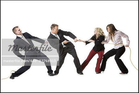 Business people engaged in a tug of war contest