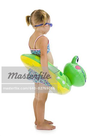 Young girl with inflatable flotation device around waist