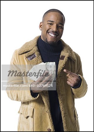 African American man holding a pile of dollar bills