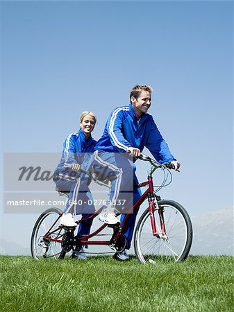 Couple riding on a tandem bicycle