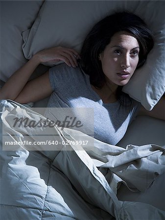 Woman in bed in the dark