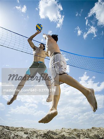 Jumping volleyball players