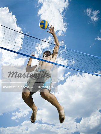 Jumping volleyball players