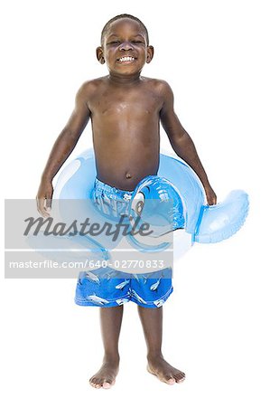 Boy with swim trunks and inflatable toy