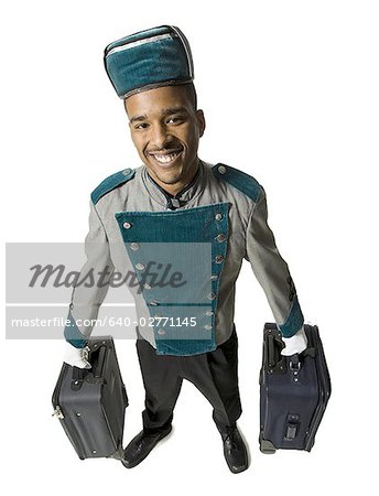 Bellboy with luggage smiling