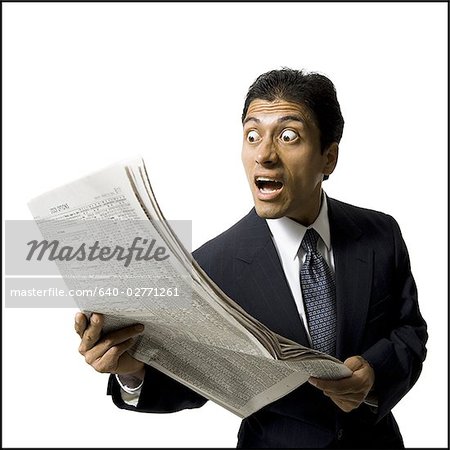 Businessman reading newspaper