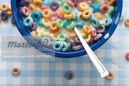 Bowl of cereal detailed view with spilled milk on tablecloth