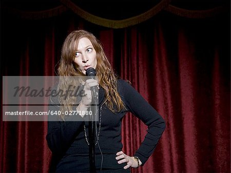 Man in suit with microphone making funny faces