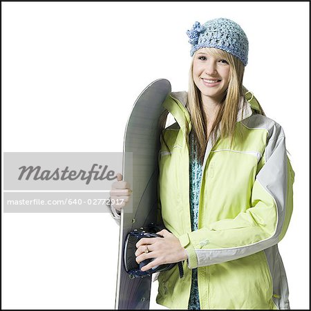 Girl with winter hat and skis smiling