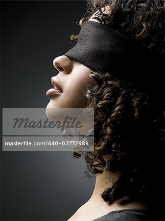 Profile of a blindfolded woman - Foto de stock - Masterfile