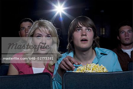 Garçon et fille avec pop-corn peur au cinéma