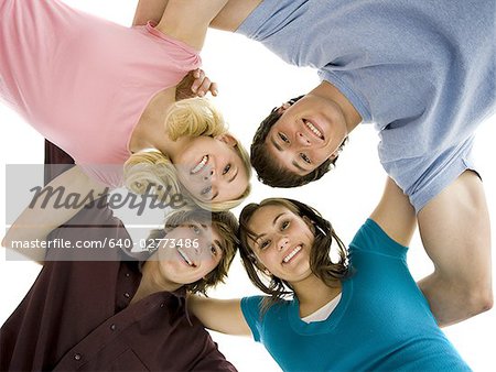 Low level view of four people smiling