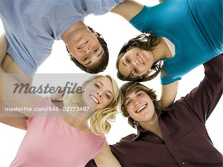 Low level view of four people smiling