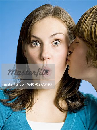 Closeup of boy kissing girl on cheek