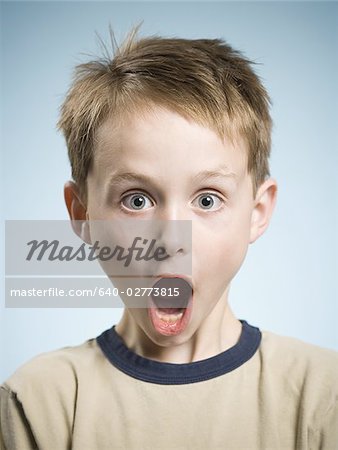 Boy with hands on face and mouth open surprised