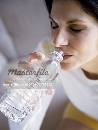 Woman sitting and drinking bottled water