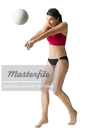 Woman in bikini playing volleyball