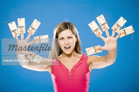 Woman with ten mousetraps on fingers and thumbs